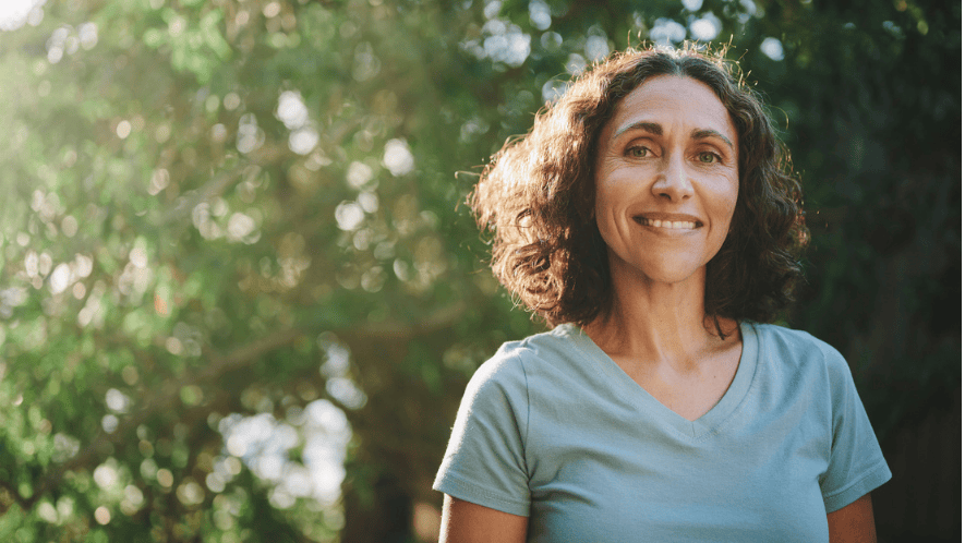 Photograph of a woman with trees in the background
