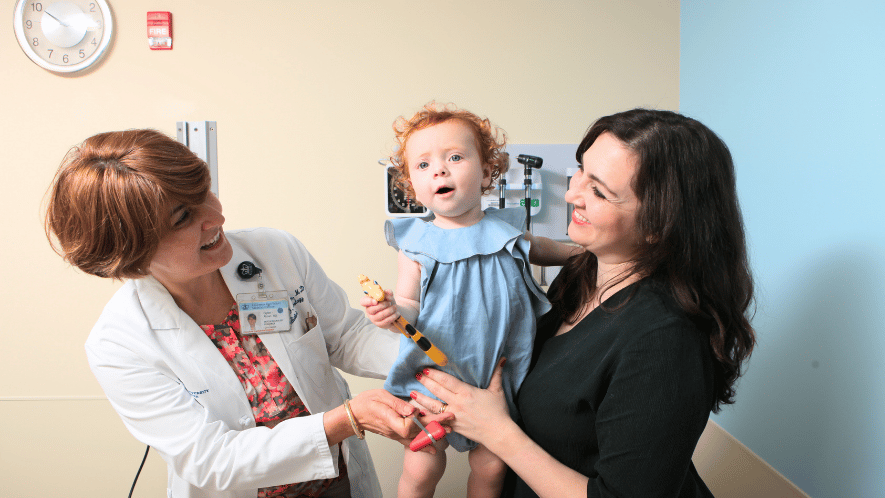 Photo of Columbia doctor with a child and her mother