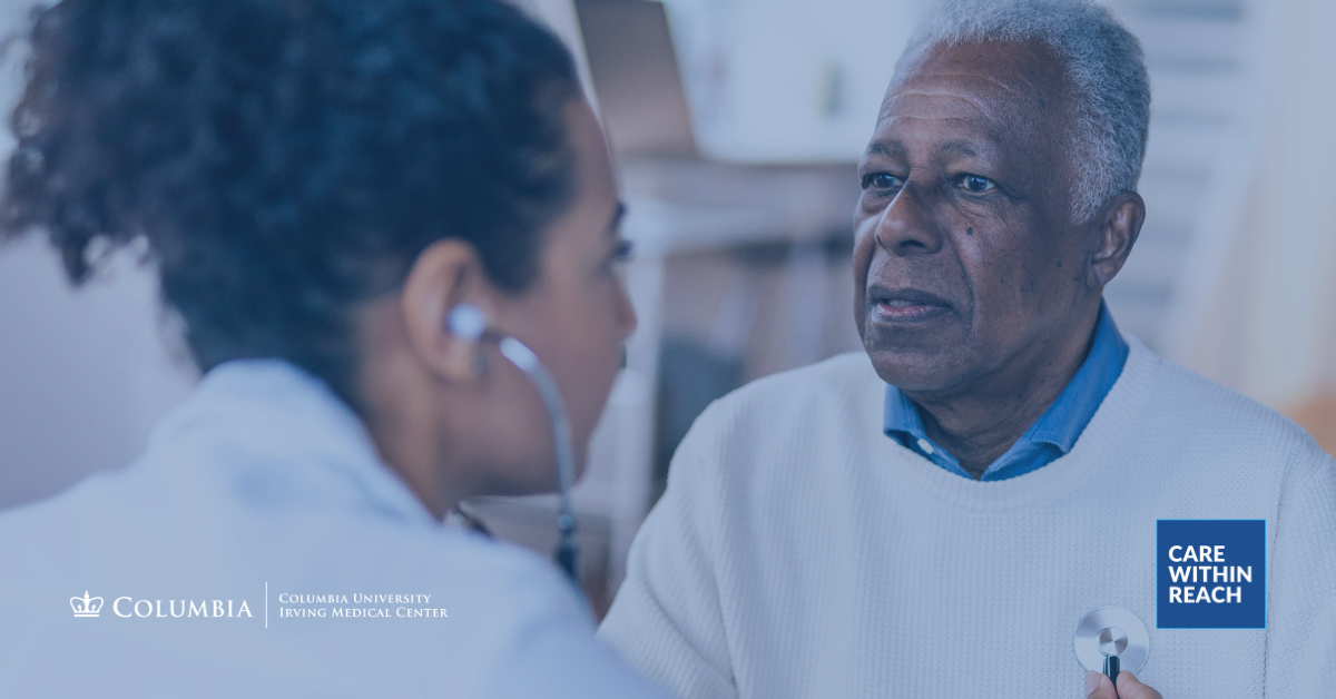 An elderly patient in good health speaks with a physician whose back is to the viewer.