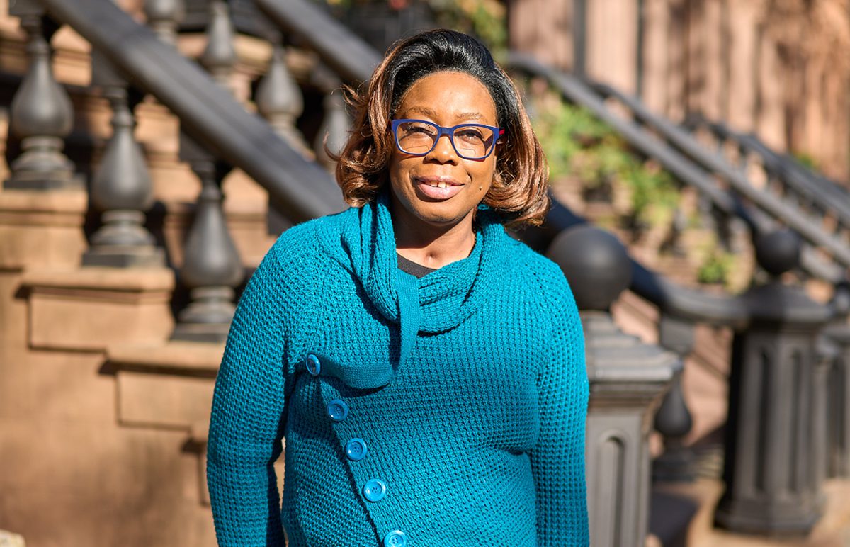 Nadine stands outside her New York City stoop