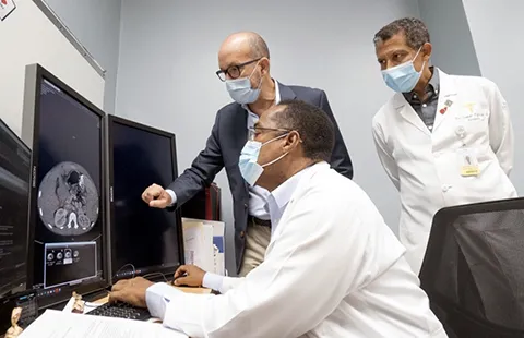 The team in the Dominican Republic prepares for months before transplant. Here they review scans. (Image courtesy of FundaHigadoAmerica)