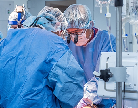 Heart surgeon Hiroo Takayama operating on a patient along with another surgeon.