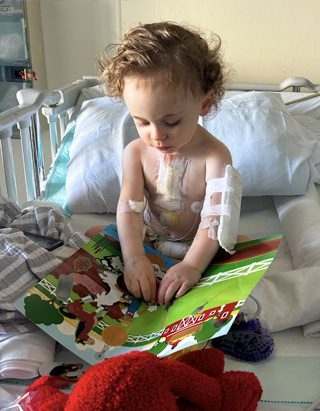 John reads a book in recovery after heart transplant