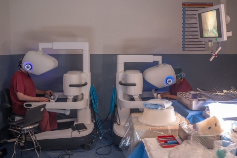 two surgeons at robot