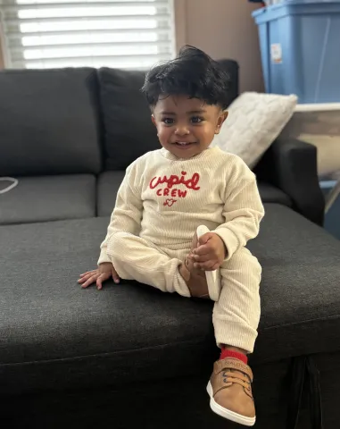 Eric sitting on a sofa at 18 months