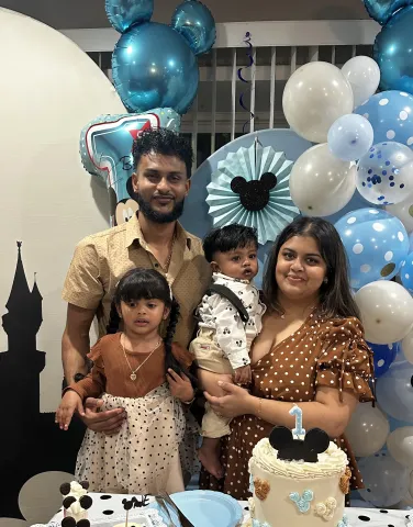 family poses at birthday party