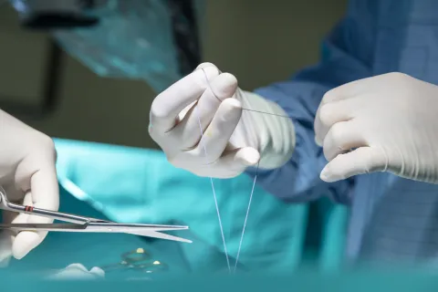 doing surgical stitches