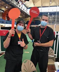 Noah Landguth and Joe Lorenz with vaccine volunteers at the Armory.