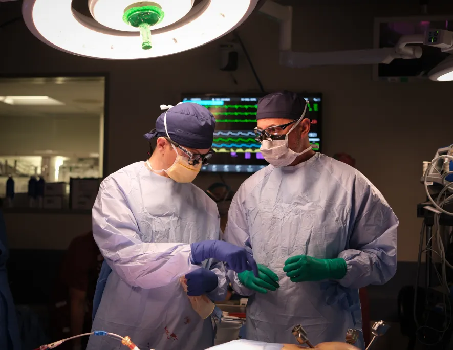Two doctors working together during a robotic procedure