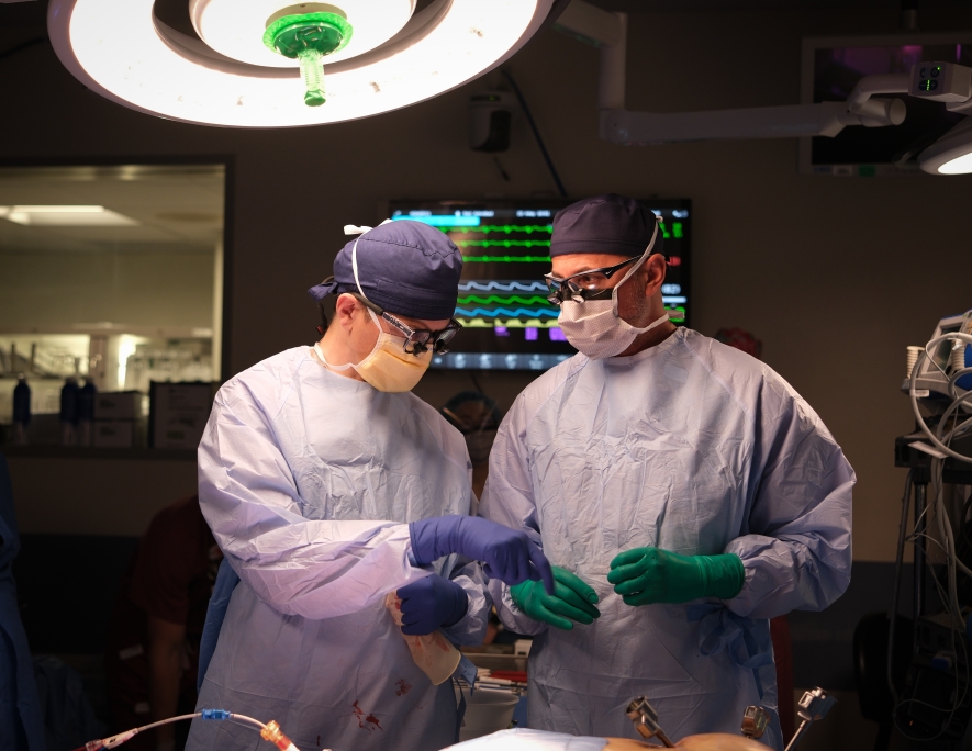 Two doctors working together during a robotic procedure