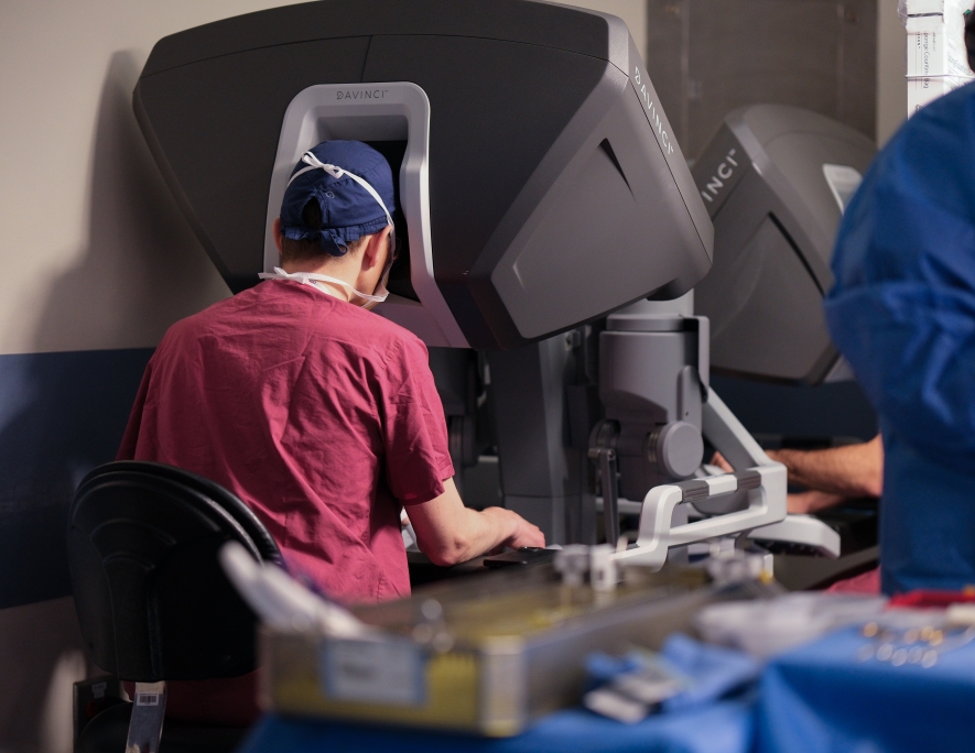 Photo of doctor working at the console controls for the robotic surgery system
