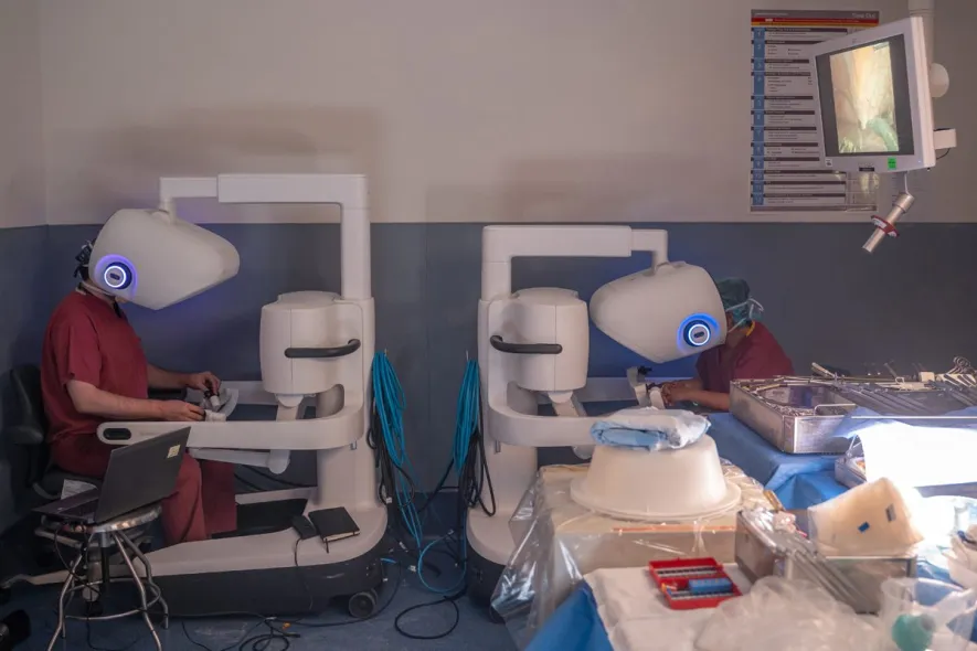 two surgeons at robot