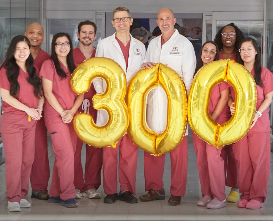 Photograph of cardiac team holding balloons in celebration