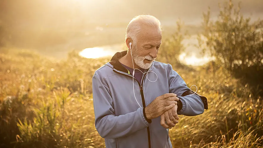  Photo: Active Senior using Smart Watch measuring heart rate