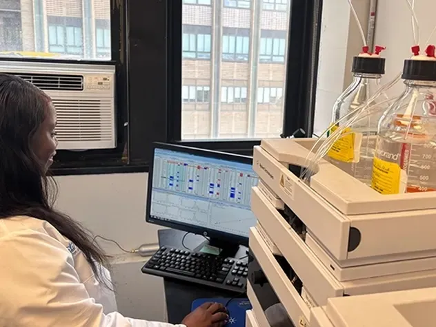 photo of a lab, scientist working at computer