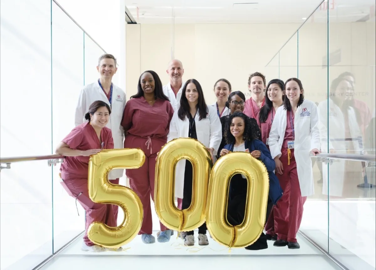 Group photo of the robotic heart surgery team with balloons