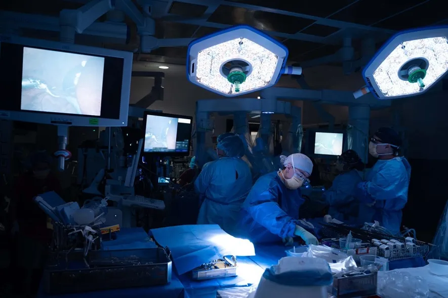 wide shot of the operating room during robotic liver transplant