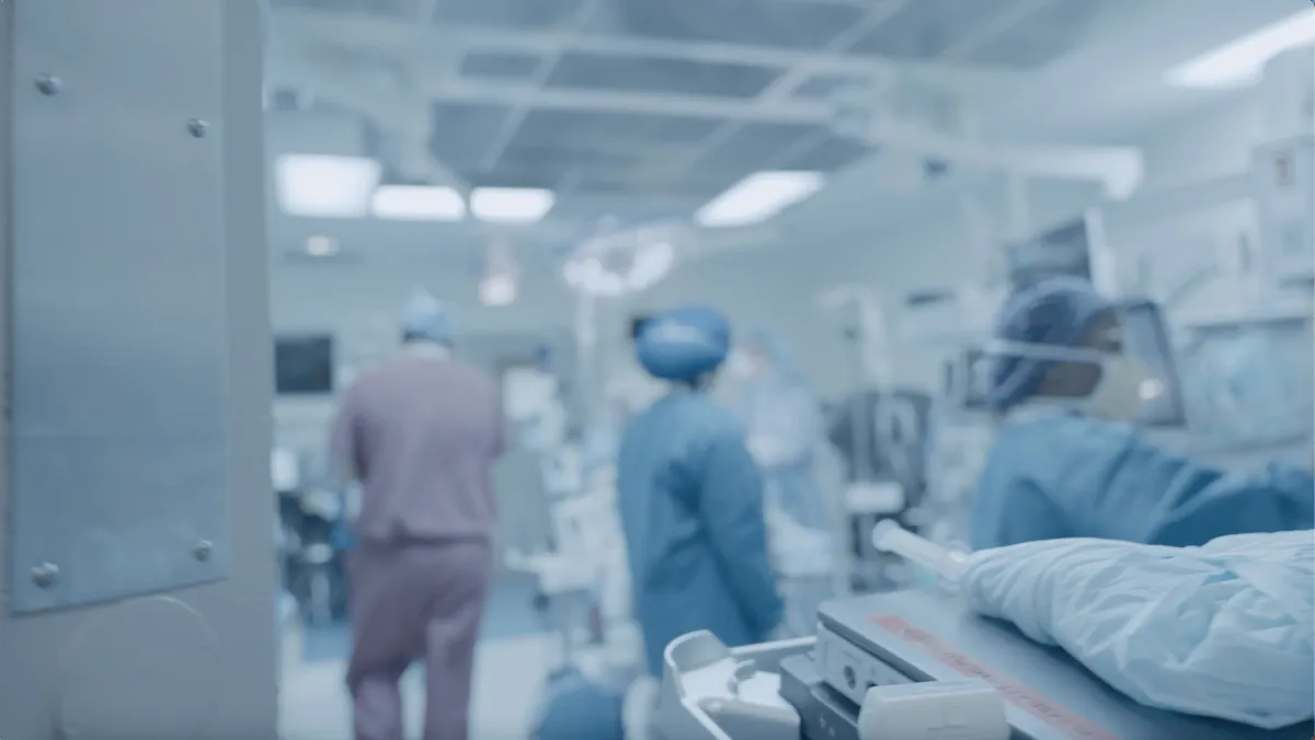 Action shot of a surgeon walking into the operating room