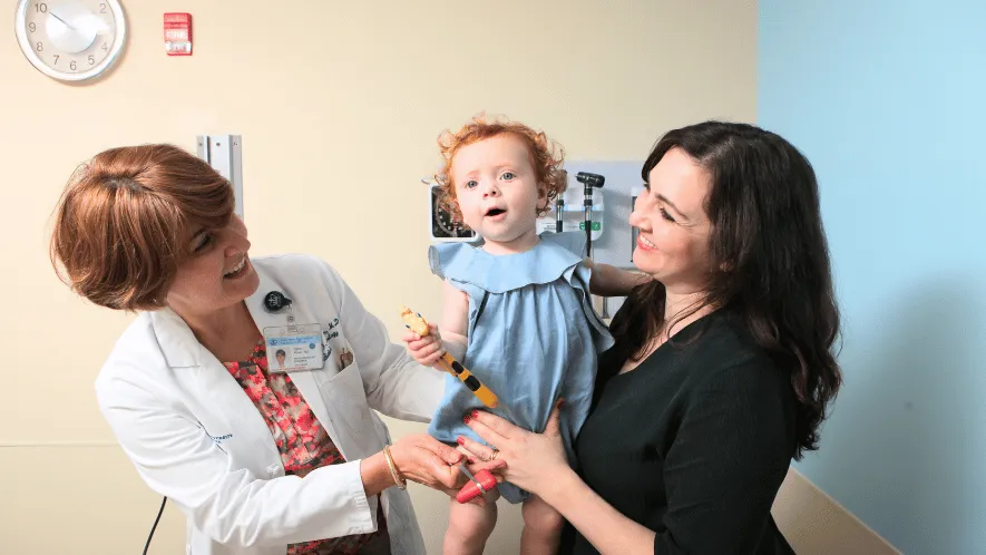 Photo of Columbia doctor with a child and her mother