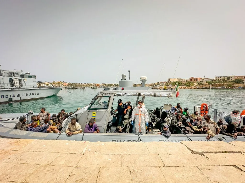 Migrants arriving into the port of Lampedusa