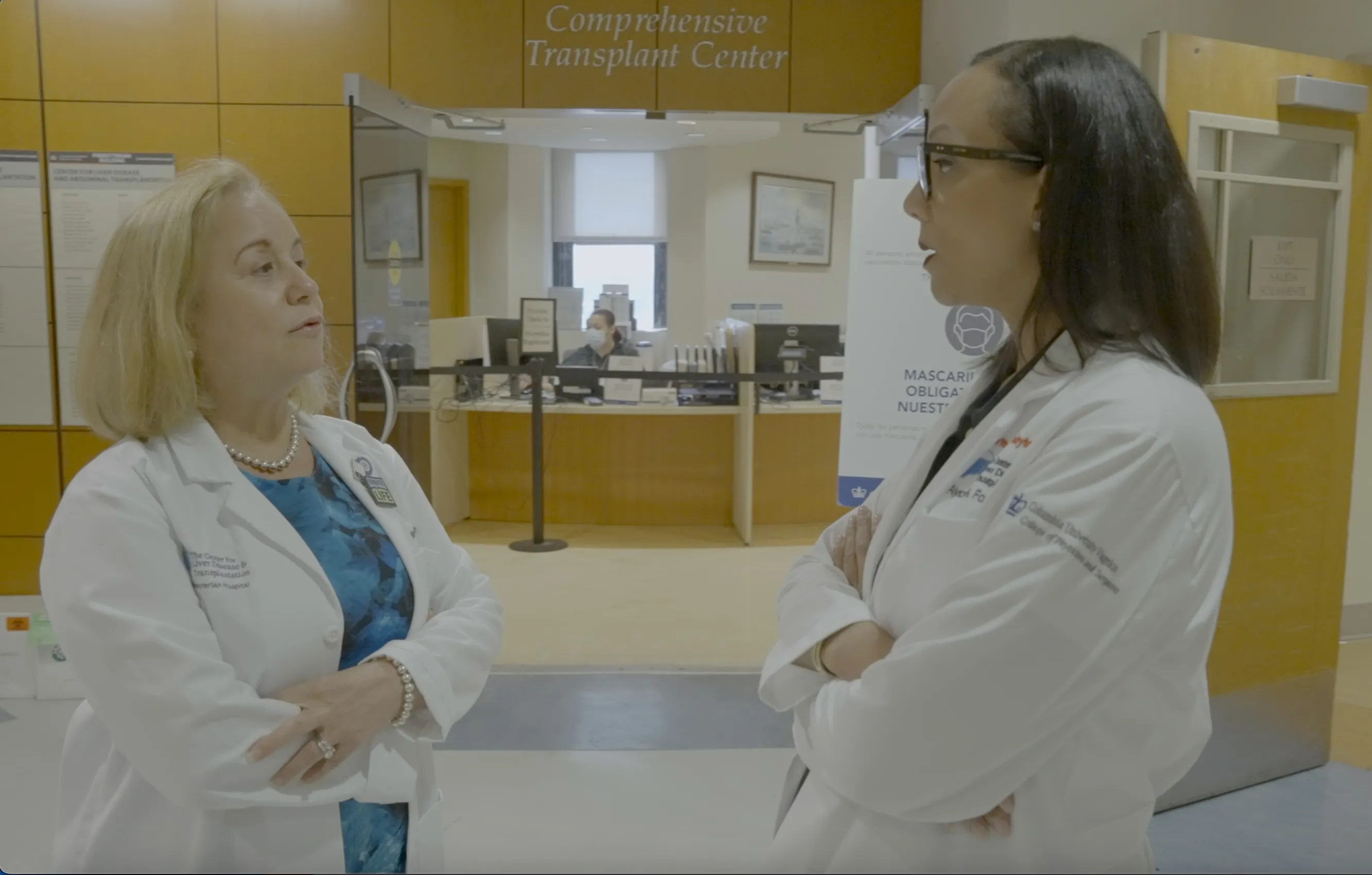 Two transplant doctors, Dr. Fox and Dr. Martinez talk in hospital hallway