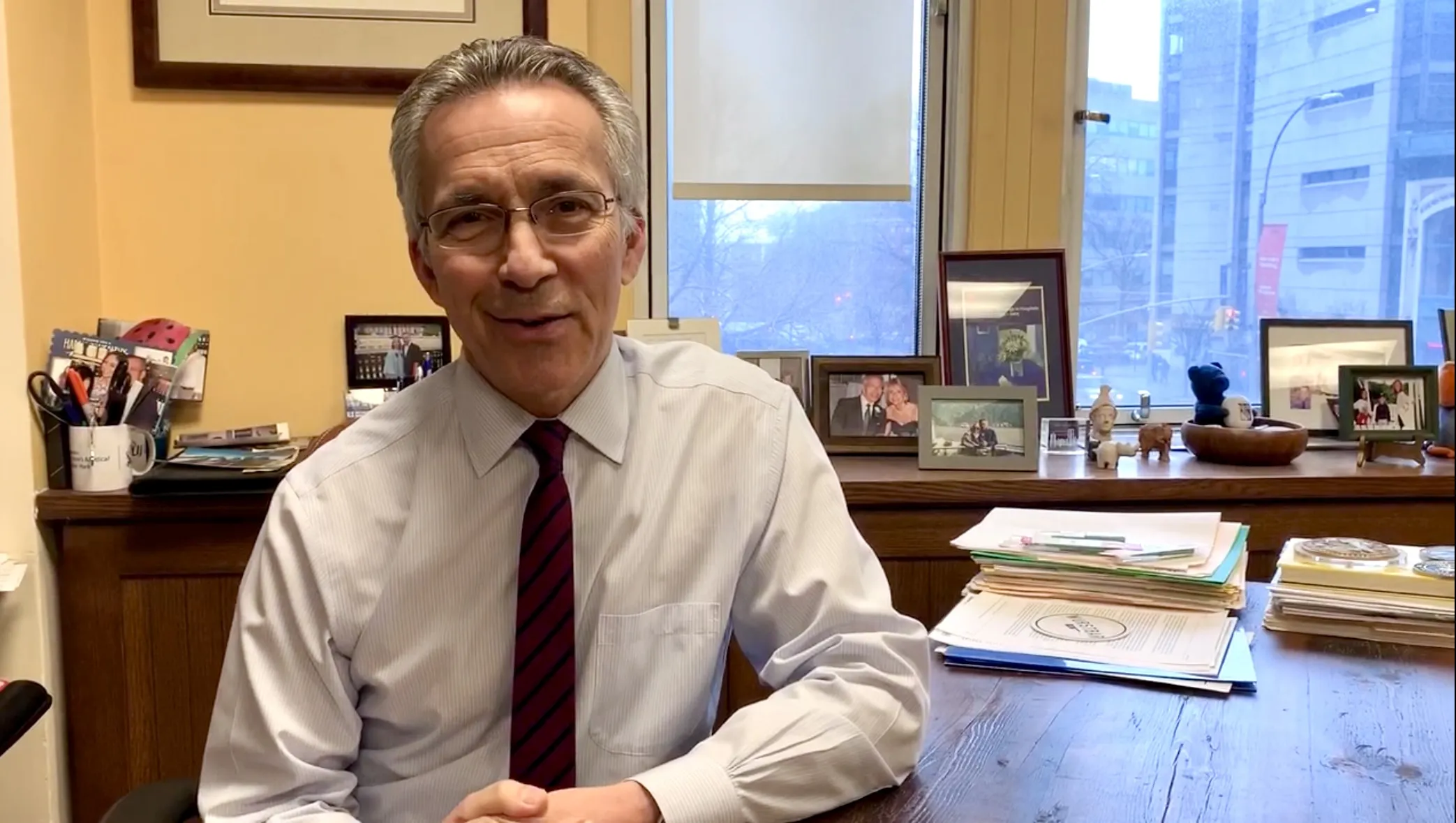 Dr. Steven Stylianos sits at his desk.