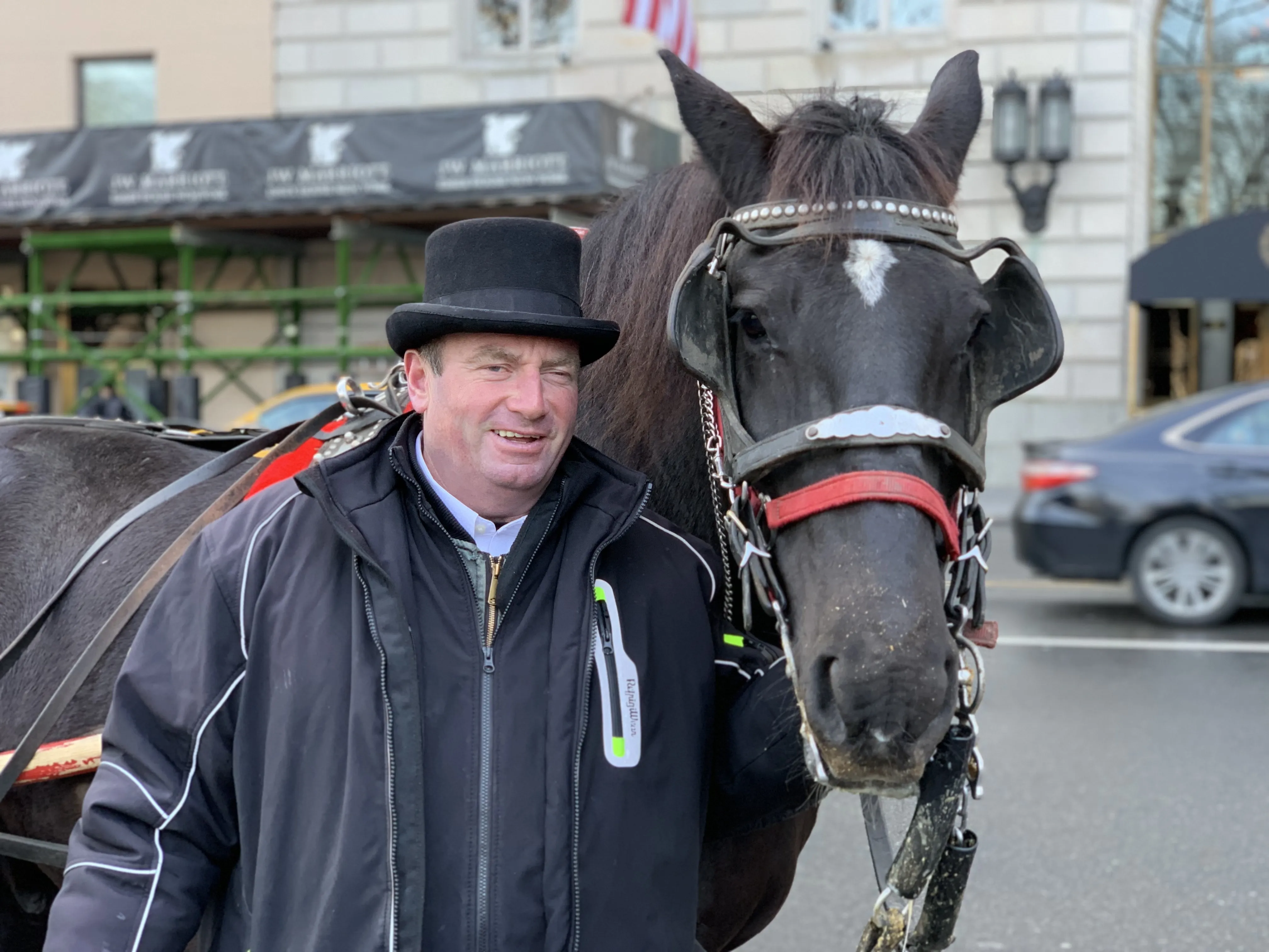 Kieran stands with his horse in central park