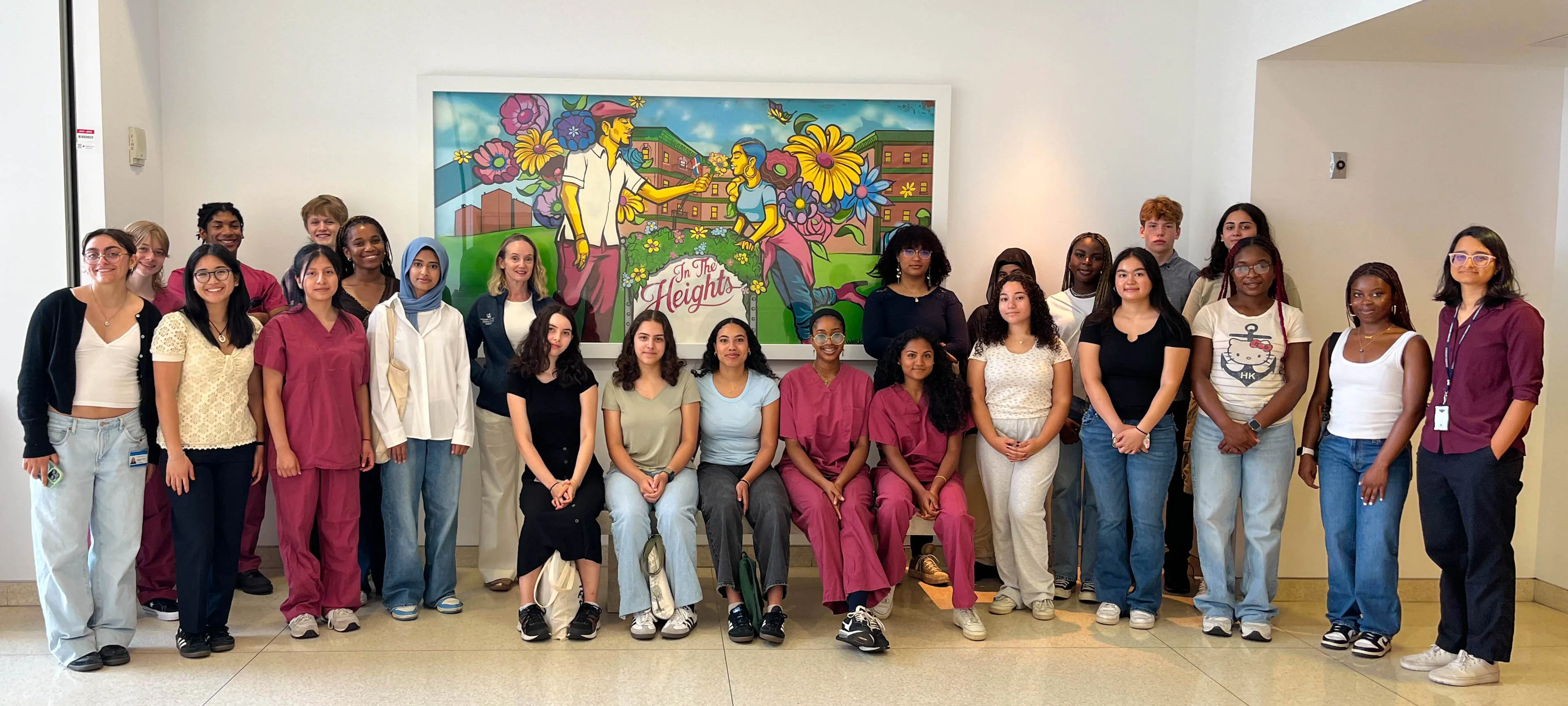 Program students stand in front on the "In the Heights" mural at Columbia-NYP Hospital.