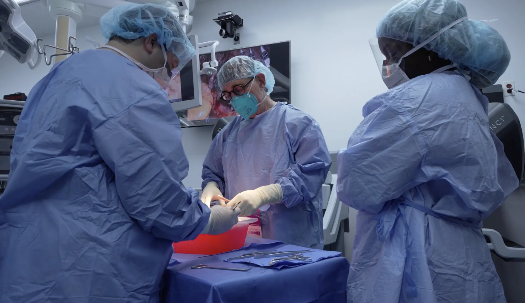 two surgeons prepare a kidney for transplant in the OR